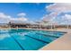 Community lap pool with adjacent lounge area at 23059 E Pummelos Rd, Queen Creek, AZ 85142