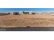 Spacious backyard with gravel, artificial grass, and home view at 24421 W Morning Vista Ln, Wittmann, AZ 85361