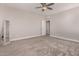 Bright bedroom with ceiling fan, neutral wall colors, and carpet flooring at 24421 W Morning Vista Ln, Wittmann, AZ 85361