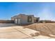 Gray one-story home with attached garage and desert landscaping at 24421 W Morning Vista Ln, Wittmann, AZ 85361