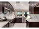 Modern kitchen featuring dark cabinetry and white countertops at 24421 W Morning Vista Ln, Wittmann, AZ 85361