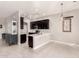 Modern kitchen with dark cabinetry, quartz countertops, and stainless steel appliances at 24421 W Morning Vista Ln, Wittmann, AZ 85361