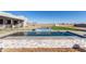 Modern pool and spa with waterfall feature and stone cladding at 24421 W Morning Vista Ln, Wittmann, AZ 85361