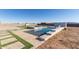 Luxury pool with spa, stonework, and flagstone decking at 24421 W Morning Vista Ln, Wittmann, AZ 85361