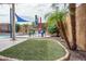 Landscaped backyard with artificial turf and colorful patio furniture at 26133 W Yukon Dr, Buckeye, AZ 85396