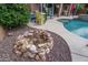 Fire pit area nestled in the backyard, near the pool and patio at 26133 W Yukon Dr, Buckeye, AZ 85396