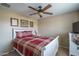 Bedroom with plaid bedding and white dresser at 26133 W Yukon Dr, Buckeye, AZ 85396