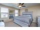 Primary bedroom with gray bedding and ceiling fan at 26133 W Yukon Dr, Buckeye, AZ 85396