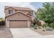 Two-story house with tan exterior and two-car garage at 26133 W Yukon Dr, Buckeye, AZ 85396