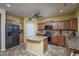 Spacious kitchen with an island, wood cabinets, and granite countertops at 26133 W Yukon Dr, Buckeye, AZ 85396