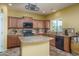 Well-equipped kitchen with wood cabinets, granite countertops, and stainless steel appliances at 26133 W Yukon Dr, Buckeye, AZ 85396