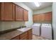 Laundry room with washer, dryer, and cabinets at 26133 W Yukon Dr, Buckeye, AZ 85396