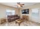 Relaxing living room with a large TV and ample natural light at 26133 W Yukon Dr, Buckeye, AZ 85396