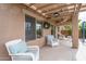 Covered patio with comfortable seating and ceiling fan at 26133 W Yukon Dr, Buckeye, AZ 85396