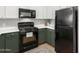 Updated kitchen with black appliances and green cabinets at 29606 N Tatum Blvd # 161, Cave Creek, AZ 85331