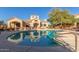 Community pool with surrounding lounge chairs and patio area at 29606 N Tatum Blvd # 161, Cave Creek, AZ 85331