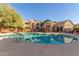 Community pool with surrounding lounge chairs at 29606 N Tatum Blvd # 161, Cave Creek, AZ 85331