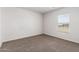 Spacious bedroom with neutral carpeting and large window at 32014 N Redding St, Wittmann, AZ 85361