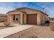 New construction home with a brown garage door and small front yard at 32014 N Redding St, Wittmann, AZ 85361