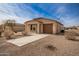 Recently built home with a brown garage door and gravel driveway at 32014 N Redding St, Wittmann, AZ 85361