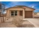 Newly built home with a brown garage door and gravel driveway at 32014 N Redding St, Wittmann, AZ 85361