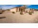 Tan house with a gravel yard and drought-tolerant landscaping at 32014 N Redding St, Wittmann, AZ 85361