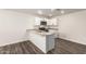 Modern kitchen with white cabinets, granite countertops, and stainless steel appliances at 32014 N Redding St, Wittmann, AZ 85361