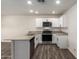 Modern kitchen with white cabinets, granite countertops, and stainless steel appliances at 32014 N Redding St, Wittmann, AZ 85361