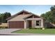 One-story home with brown garage door and landscaping at 32318 N Hermon Rd, San Tan Valley, AZ 85143