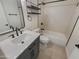 Updated bathroom with a gray vanity and a bathtub at 3334 S Elm St, Tempe, AZ 85282