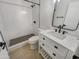 Updated bathroom with white tile, quartz countertop vanity, and walk-in shower at 3334 S Elm St, Tempe, AZ 85282