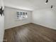 Well-lit bedroom with wood-look floors and window shutters at 3334 S Elm St, Tempe, AZ 85282