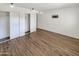 Bright bedroom with wood-look floors and mirrored closet doors at 3334 S Elm St, Tempe, AZ 85282