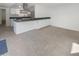 Open kitchen with island, stainless steel appliances, and dark countertops at 3334 S Elm St, Tempe, AZ 85282