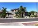 Two-story house with a landscaped yard, driveway and palm trees at 3469 E Cabazon Ct, Gilbert, AZ 85297