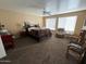 Main bedroom with king-size bed, seating area, and large windows at 3469 E Cabazon Ct, Gilbert, AZ 85297