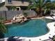 Relaxing kidney-shaped pool with a rock waterfall and tiled border at 3469 E Cabazon Ct, Gilbert, AZ 85297