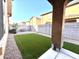 Landscaped backyard with artificial turf and covered patio at 3948 E Morelos St, Gilbert, AZ 85295