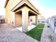 Covered patio and artificial turf backyard with gravel at 3948 E Morelos St, Gilbert, AZ 85295