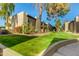 A landscaped green area with trees and flowers, featuring the condo's exterior at 4201 E Camelback Rd # 25, Phoenix, AZ 85018