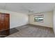 Comfortable living room featuring neutral carpet, a ceiling fan, natural light, and direct access via an inviting front door at 4201 E Camelback Rd # 25, Phoenix, AZ 85018