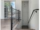 Interior entryway with wood floors, metal railing, and door to hallway at 421 W 6Th St # 1009, Tempe, AZ 85281