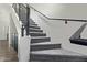 Modern staircase with gray carpeting and black metal railing at 421 W 6Th St # 1009, Tempe, AZ 85281