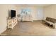 Living room with sofa, TV, and shelving at 4216 N 72Nd Ln, Phoenix, AZ 85033