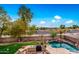 Backyard features a pool, outdoor kitchen, and string lights at 4221 E Carriage Way, Gilbert, AZ 85297