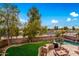 Aerial view showcasing a backyard with pool, grassy area, and outdoor kitchen at 4221 E Carriage Way, Gilbert, AZ 85297