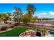 Backyard view with pool, outdoor kitchen, and string lights at 4221 E Carriage Way, Gilbert, AZ 85297