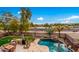 Aerial view of backyard with pool, outdoor kitchen, and lush landscaping at 4221 E Carriage Way, Gilbert, AZ 85297