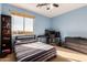 Bedroom with large window, built-in shelving, and a desk area at 4221 E Carriage Way, Gilbert, AZ 85297