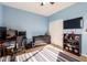 Bedroom with large window, built-in shelving, and a desk area at 4221 E Carriage Way, Gilbert, AZ 85297